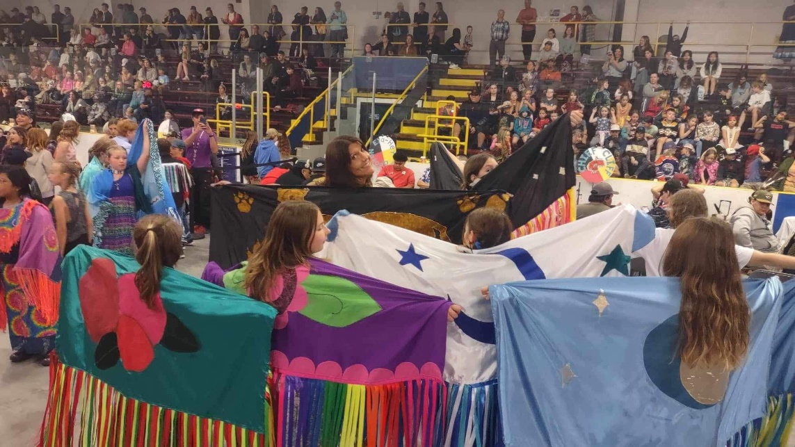 A group of people holding flags

Description automatically generated