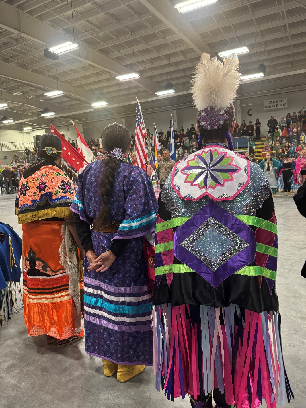 A group of people wearing colorful dresses

Description automatically generated