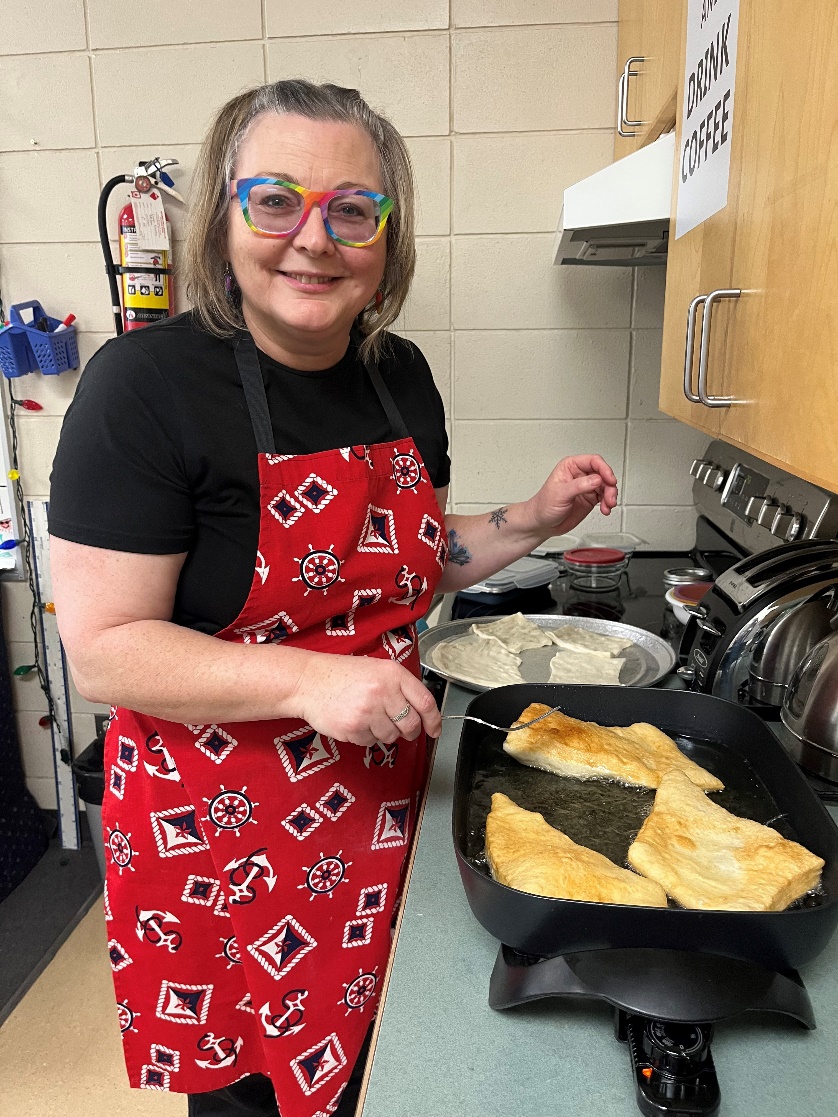 A person in a red apron cooking food

AI-generated content may be incorrect.