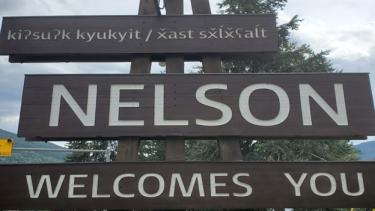 city of nelson welcome sign which includes local Indigenous languages